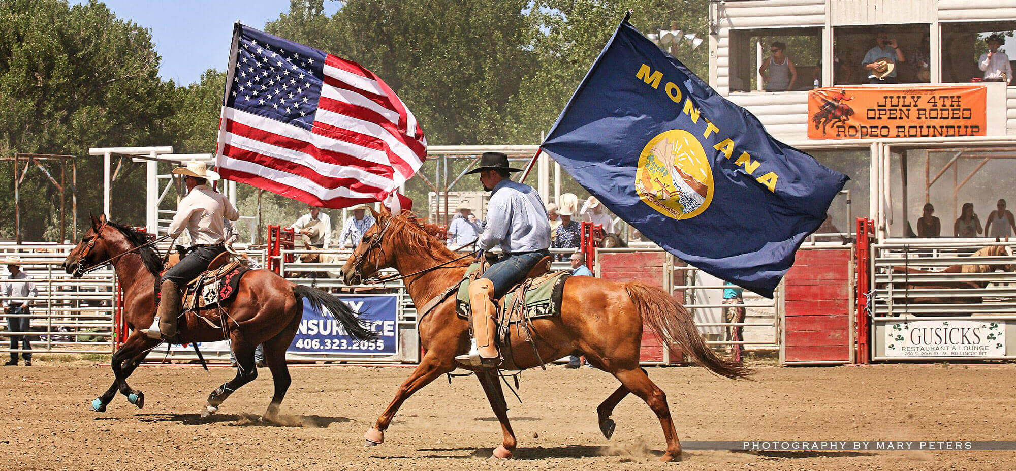 two men on horses at rodeo